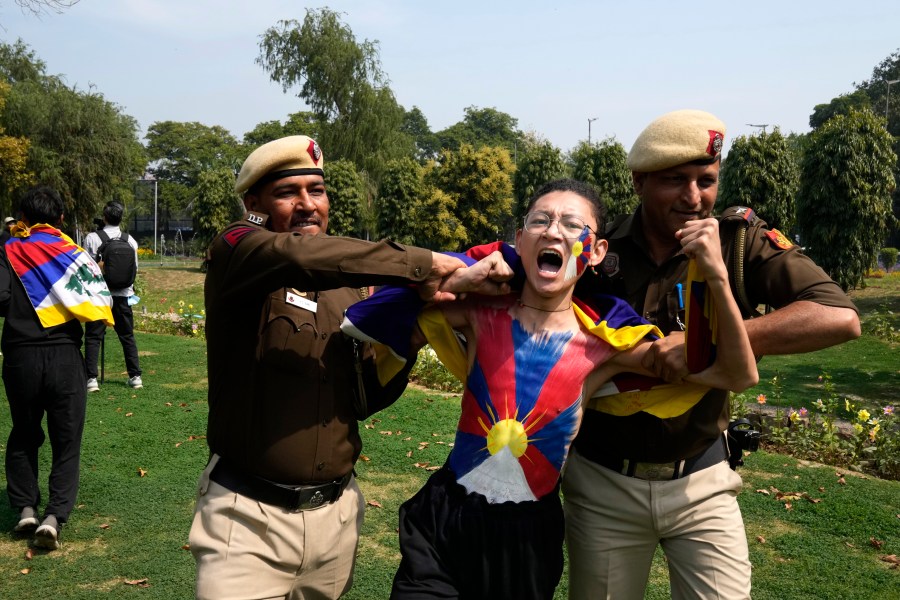 Police try to detain a protesting exile Tibetan during a protest outside Chinese embassy to mark the 1959 uprising in Tibet against the Chinese rule on this day, in New Delhi,India, Monday, March, 10, 2025. (AP Photo/Manish Swarup)