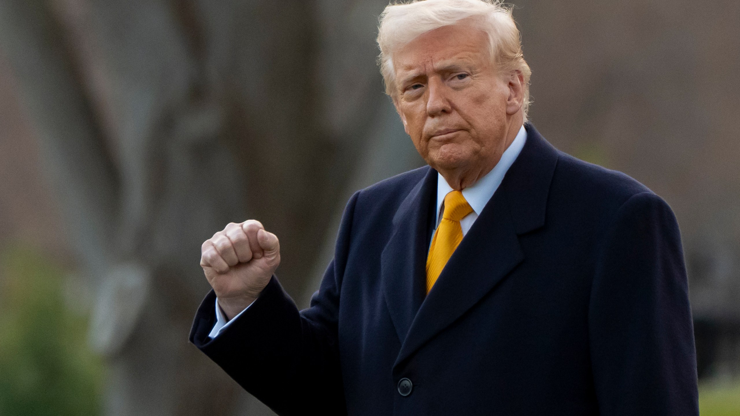 FILE - President Donald Trump pumps his fist before departing on Marine One from the South Lawn of the White House, Friday, March 7, 2025, in Washington. (AP Photo/Alex Brandon, File)