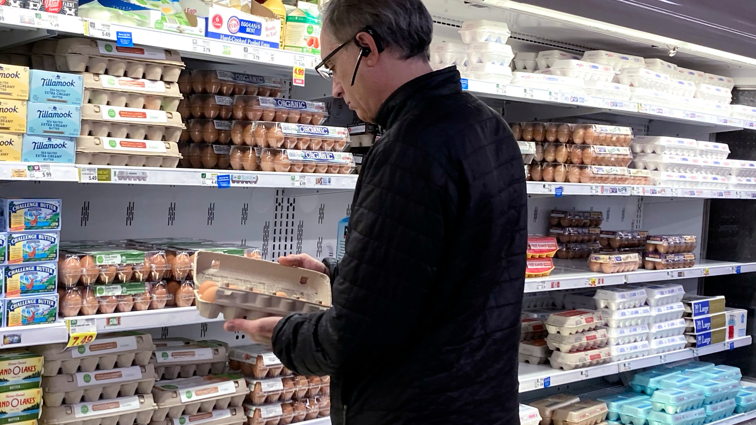 FILE - A shopper checks eggs before he purchases at a grocery store in Glenview, Ill., Tuesday, Jan. 10, 2023. (AP Photo/Nam Y. Huh, File)