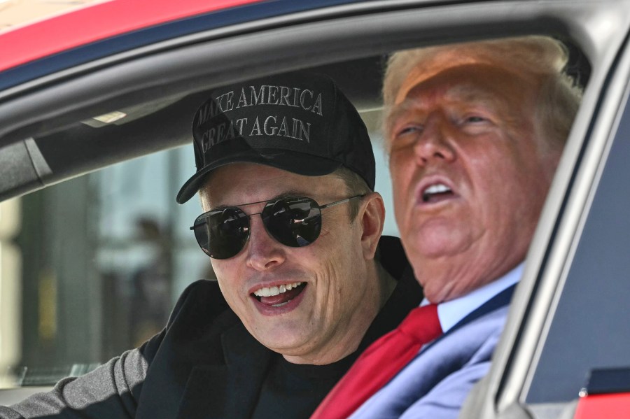 President Donald Trump and Tesla CEO Elon Musk speak to reporters as they sit in a Tesla vehicle on the South Lawn of the White House Tuesday, March 11, 2025, in Washington. (Pool via AP)